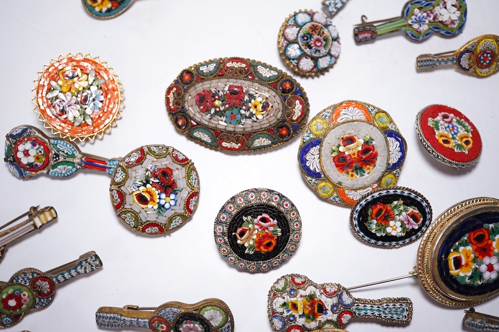A collection of twenty-eight brooches, including fourteen mixed guitar and banjo shaped brooches, six large oval brooches, seven smaller brooches and one small oval., Condition - good